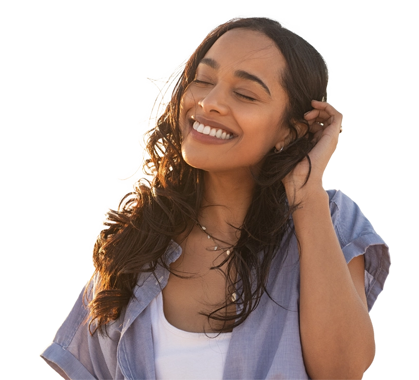A woman smiling while wearing a purple shirt.